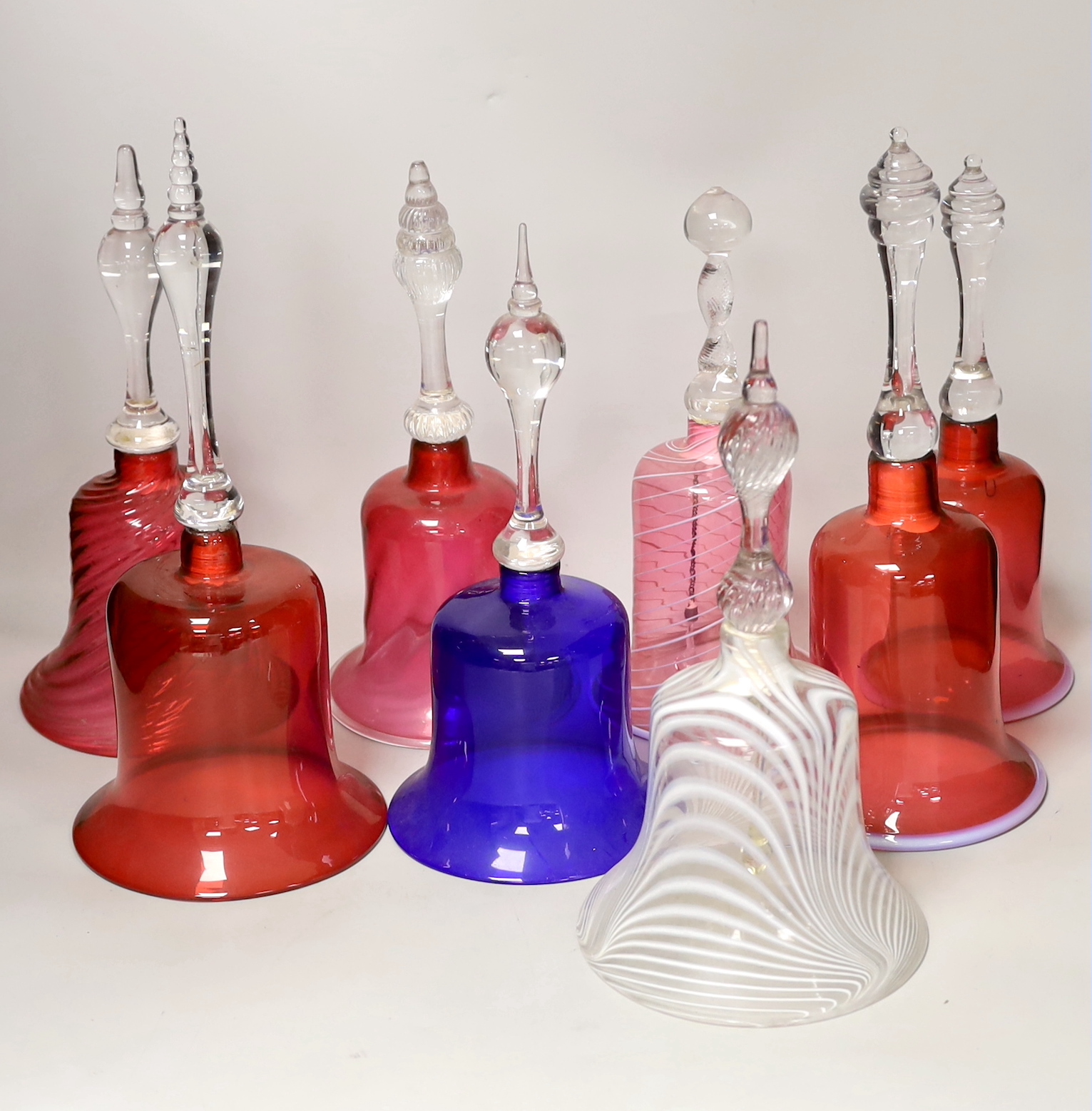 Eight Victorian coloured glass hand bells, tallest 34cm